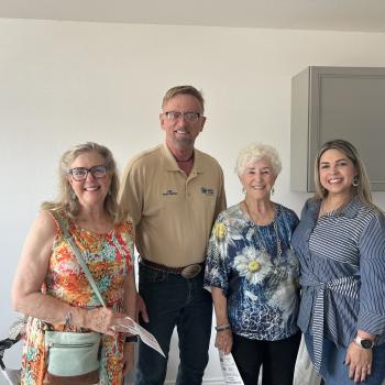 Board members and new home owner